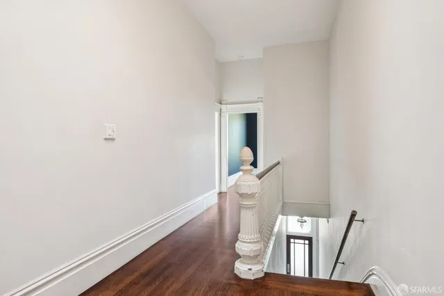a white toilet sitting next to a wooden cabinet