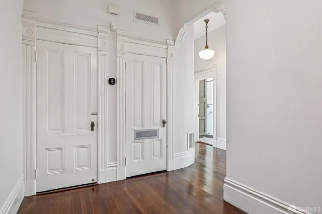a view of a hallway with wooden floor