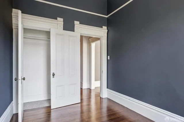 a view of a hallway with wooden floor