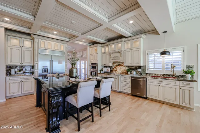 a kitchen with stainless steel appliances granite countertop a stove and a refrigerator