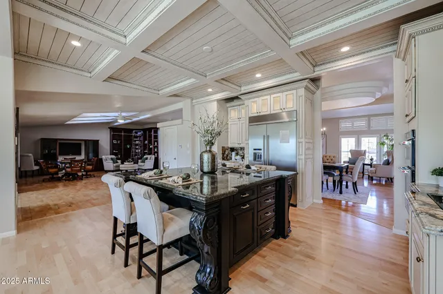 a living room with furniture a flat screen tv and a large window