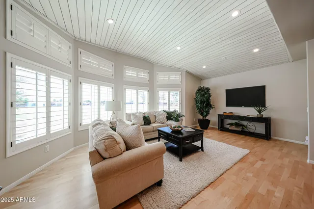 a view of an empty room with a window and cabinet