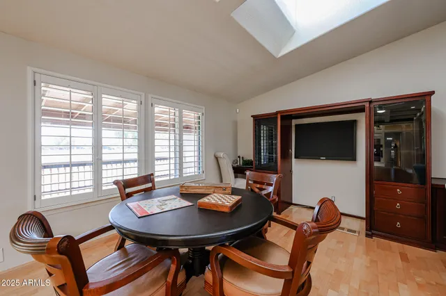 a living room with furniture a window and a clock