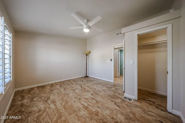 a bathroom with a large tub sink and large window