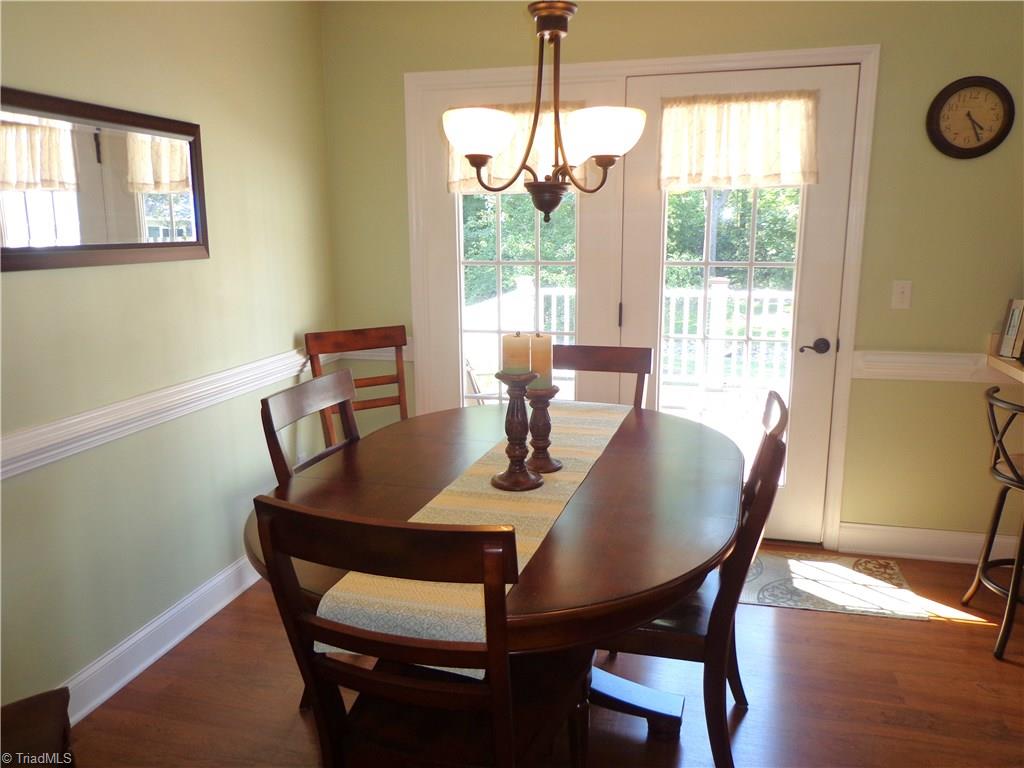 9009 Racine Road Pleasant Garden, NC 27313 - Photo 8 of 21 Dining Area w/Laminate Flooring and Chair Rail Molding