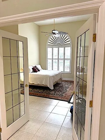 a bed sitting in a bedroom next to a window