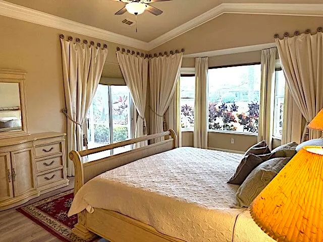 a kitchen with a large window and a view of living room