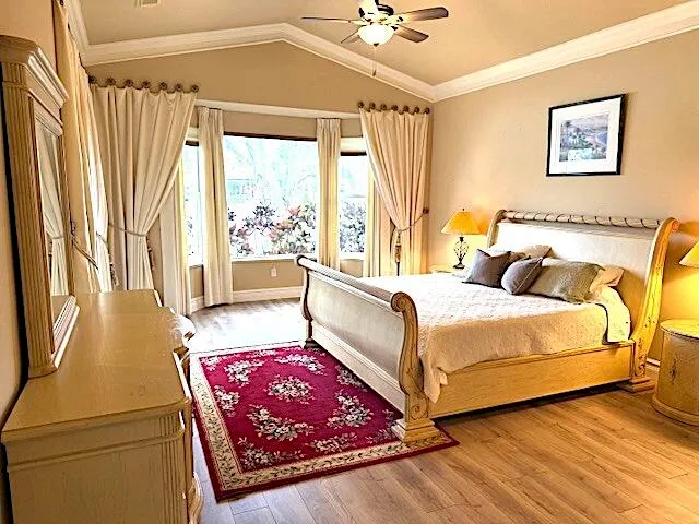 a bedroom with a bed and a window