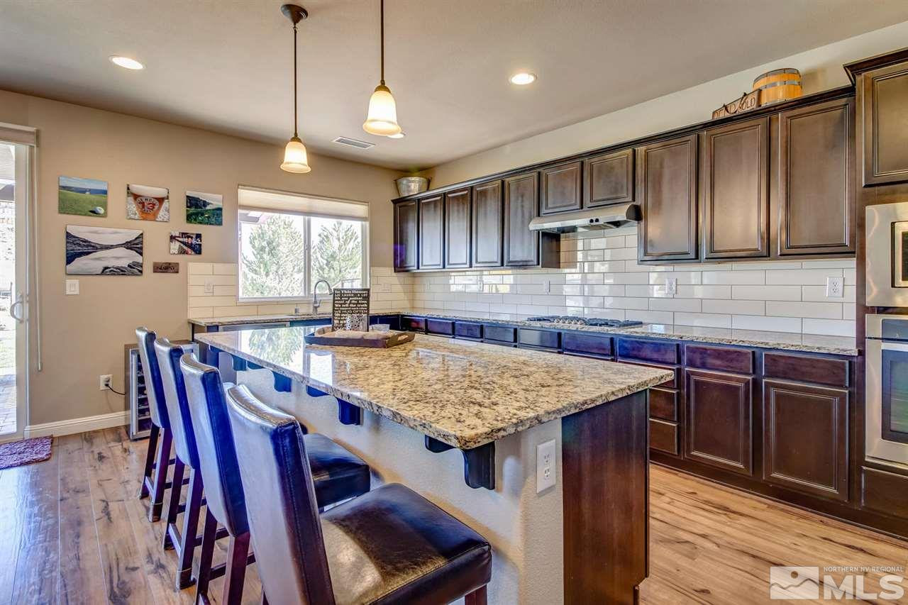 1990 Back Nine Trail Reno, NV 89523 - Photo 3 of 25 a kitchen with kitchen island a wooden cabinets and counter space
