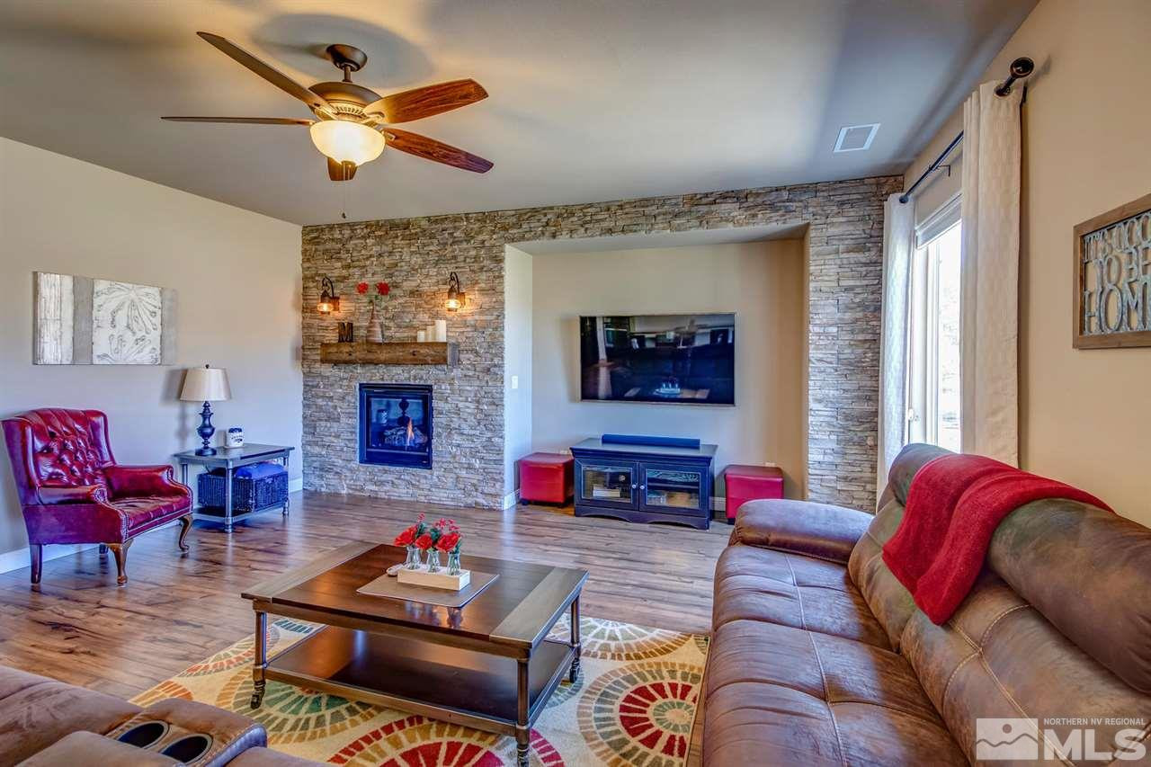 1990 Back Nine Trail Reno, NV 89523 - Photo 8 of 25 a living room with furniture a flat screen tv and a fireplace