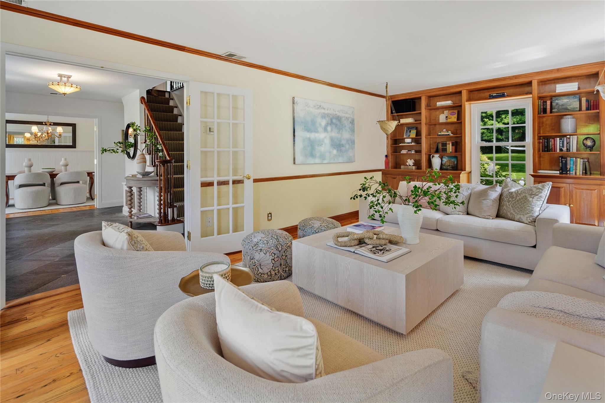 16 Fox Den Road Mount Kisco, NY 10549 - Photo 13 of 44 Front to back formal living room, cottage style 6 over 9 windows, built-in bookcases with storage cabinets below, crown molding and chair rail, oak floors