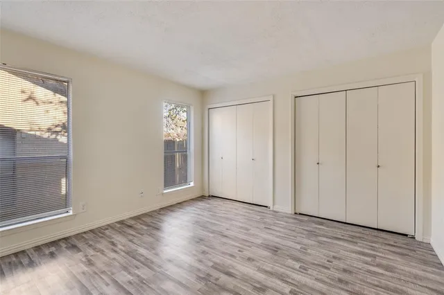 a view of a room with wooden floor