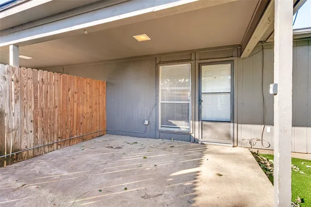 a backyard of a house with table and chairs