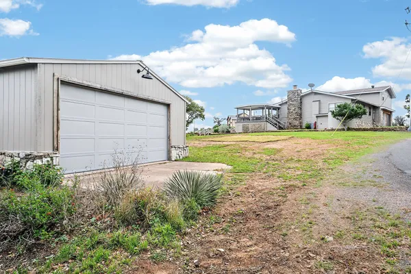 a view of a house with a yard and garage