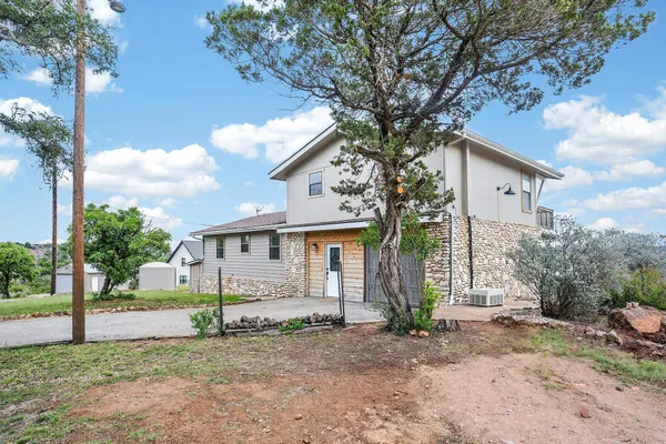 a house that has a tree in front of the house