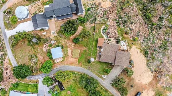 an aerial view of a house with a yard and garden