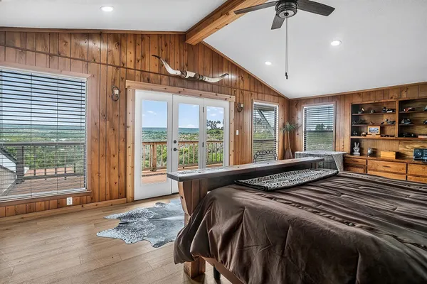 a bed sitting in a spacious bedroom next to a window