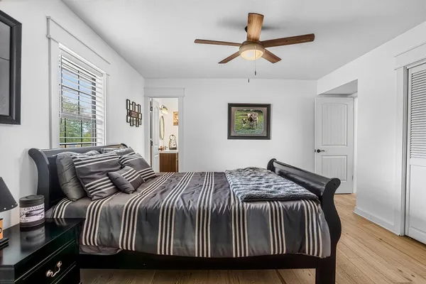 a bedroom with a bed and wooden floor