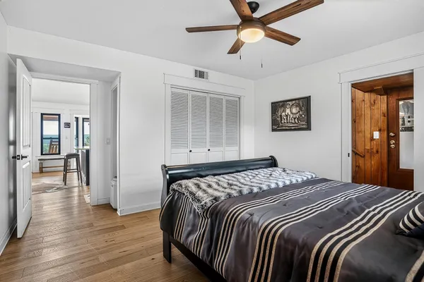 a bedroom with a bed and a chandelier