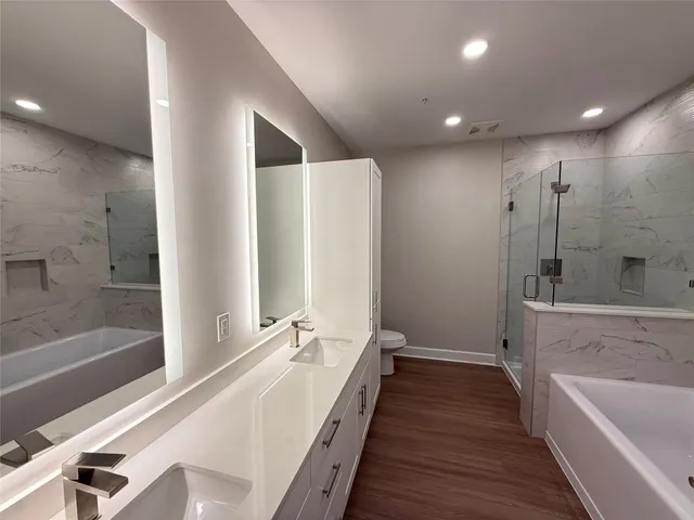 a bathroom with a double vanity sink and a large mirror