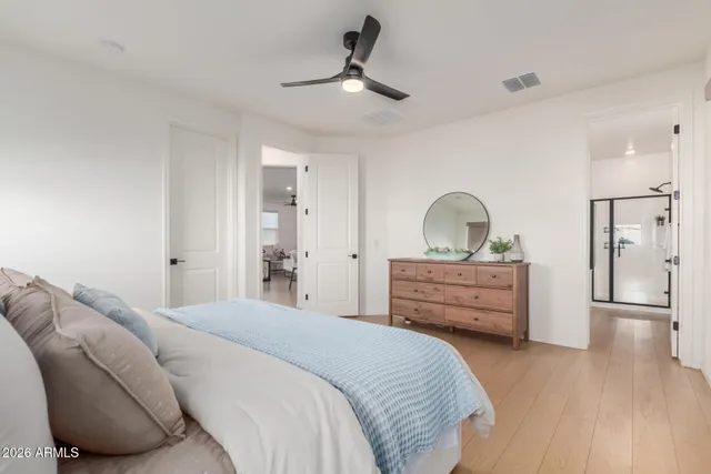 a bedroom with a bed and a painting on the wall