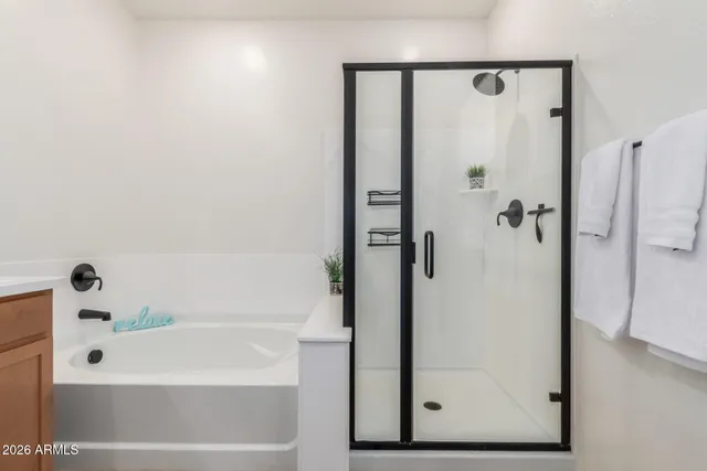 a view of walk in closet with clothes