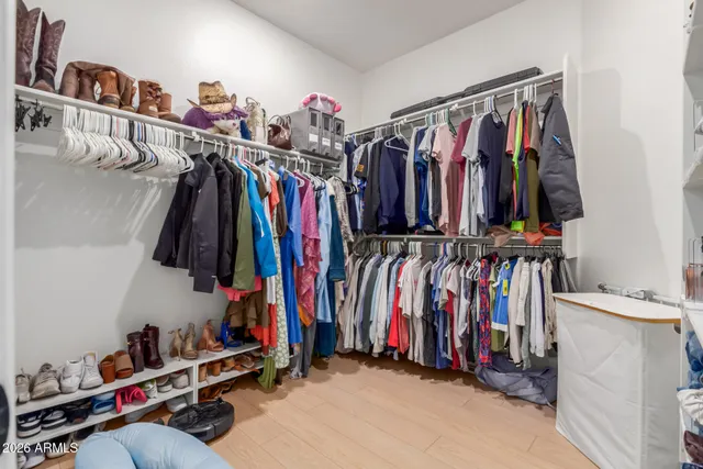a bedroom with a bed and a computer on the desk