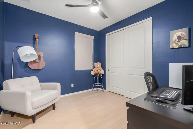 a view of a workspace with furniture and a window
