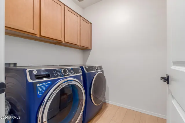 an outdoor sitting area with chairs and table in patio