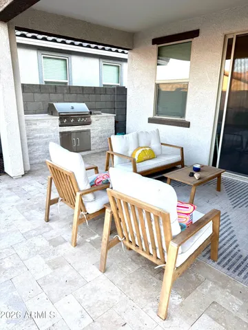 a view of a house with backyard sitting area and garden