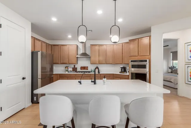 a kitchen with stainless steel appliances a table chairs and chandelier