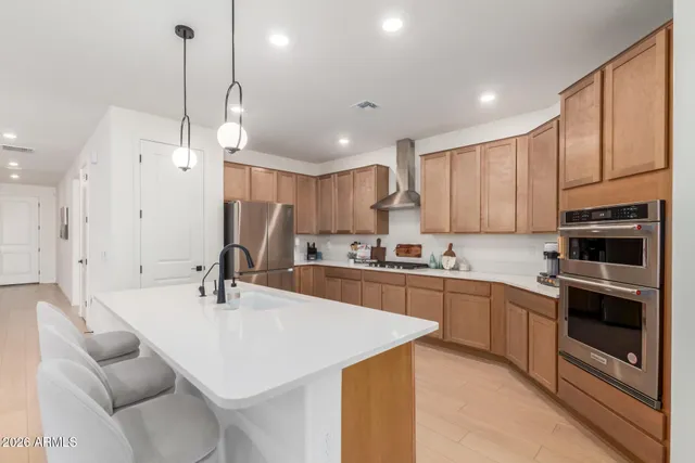 a kitchen with stainless steel appliances kitchen island granite countertop a sink and cabinets