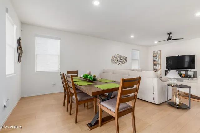 a view of a dining room with furniture and a flat screen tv