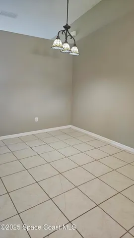 a view of a chandelier fan and fire place