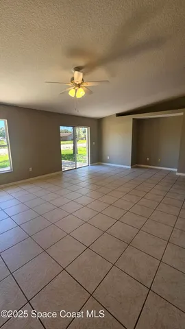 a view of wooden floor and windows in a room