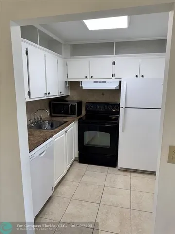 a kitchen with a cabinets and white appliances