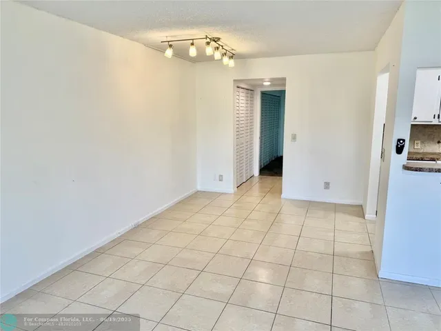 a view of a livingroom with an empty space and a window
