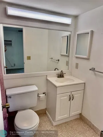 a bathroom with a sink toilet and mirror