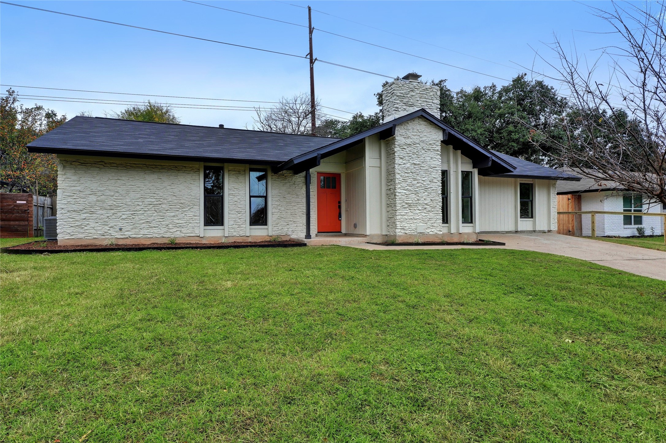 a front view of a house with a garden and yard