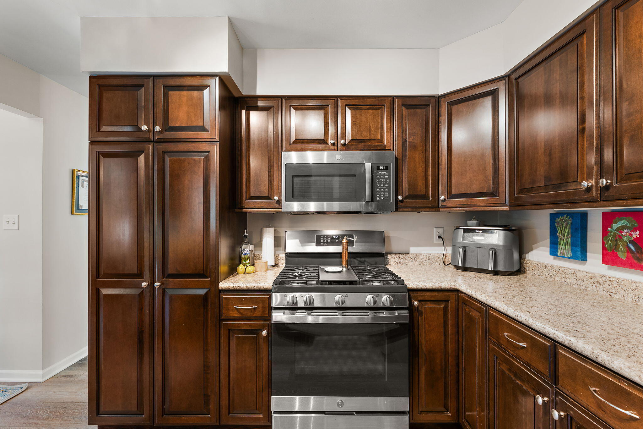 8748 Durbin Lane Crown Point, IN 46307 - Photo 16 of 47 a kitchen with granite countertop stainless steel appliances and wooden cabinets
