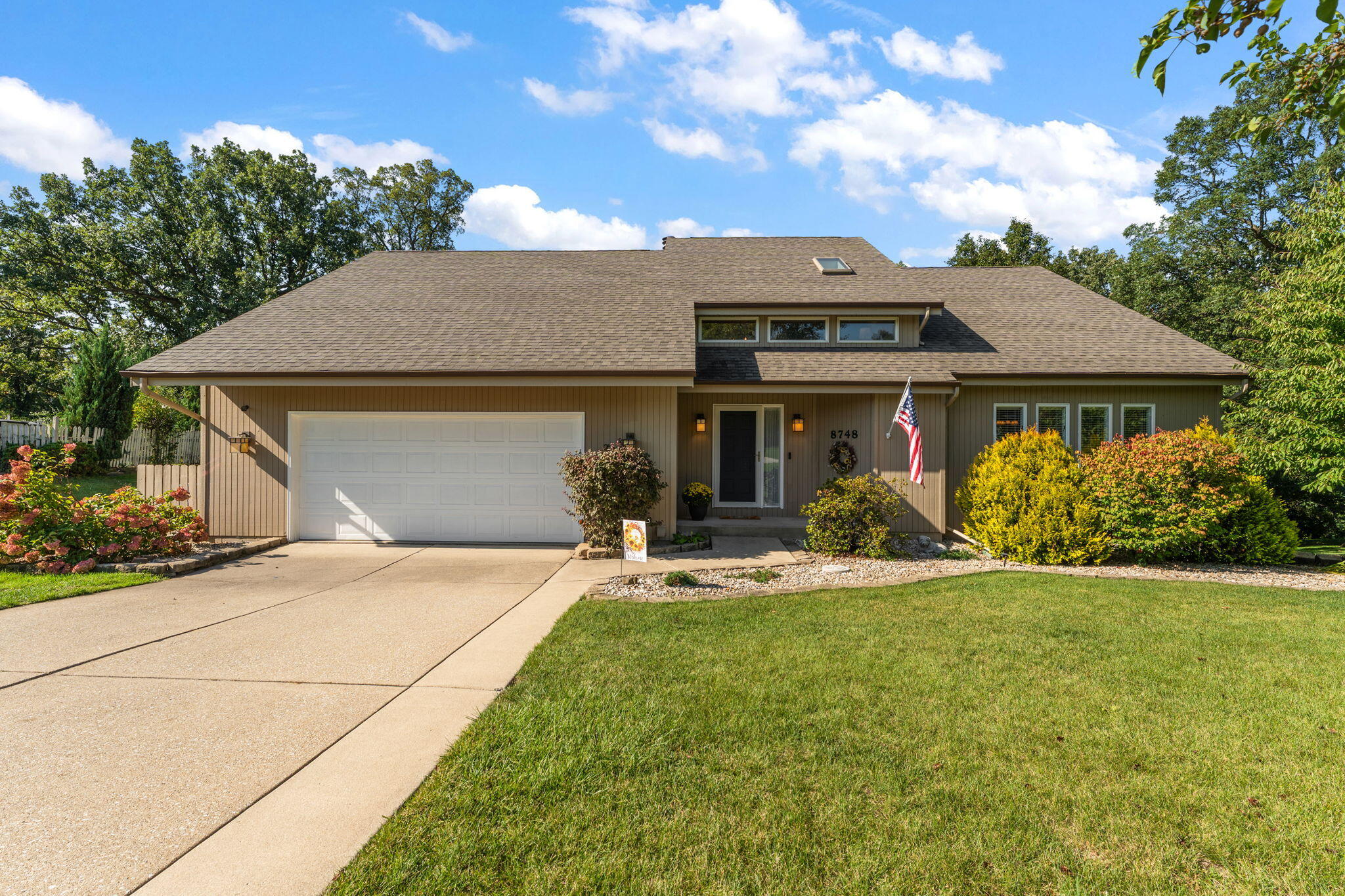 8748 Durbin Lane Crown Point, IN 46307 - Photo 2 of 47 a front view of a house with a garden and yard