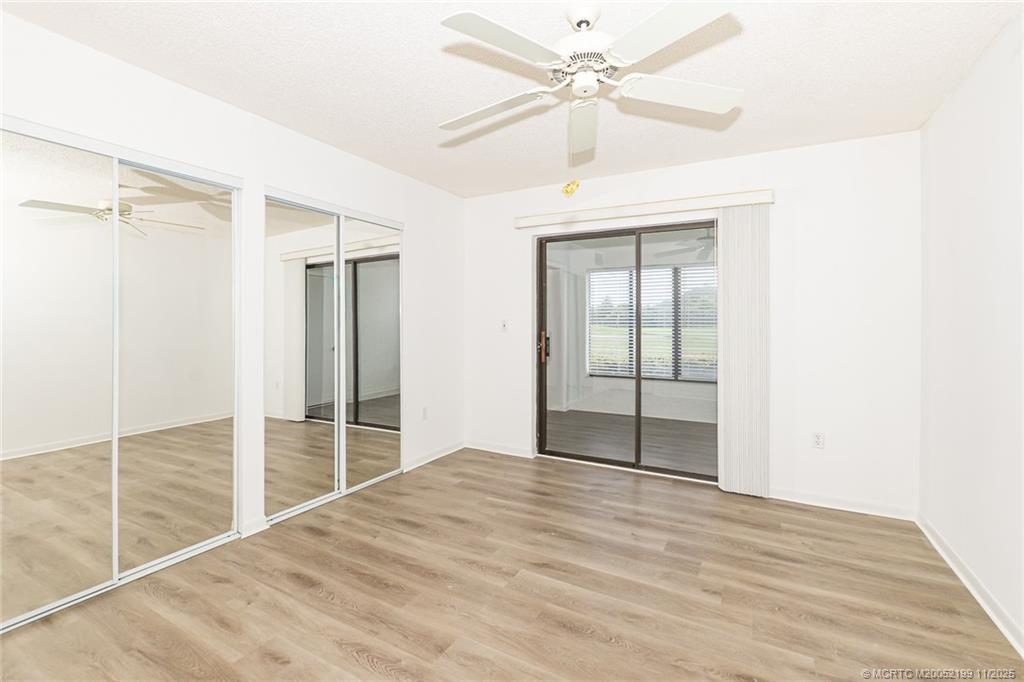 5373 Southeast Miles Grant Road, Unit C102 Stuart, FL 34997 - Photo 16 of 21 Bedroom 2, nice size, newer vinyl flooring, mirrored closet doors, fresh paint.