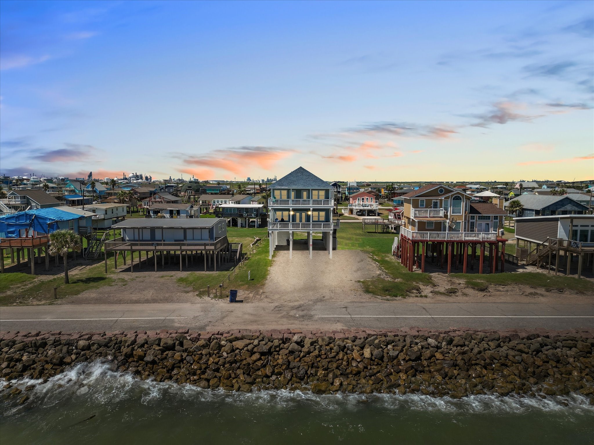718 Beach Drive Surfside Beach, TX 77541 - Photo 5 of 49 Experience serene coastal living in this exquisite home with expansive balconies and breathtaking panoramic views. Its elevated design ensures ultimate privacy, perfect for relaxation and entertaining.