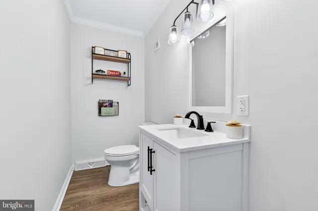 a bathroom with a sink a toilet and a mirror