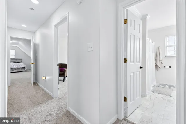a view of a hallway with bathroom and shower