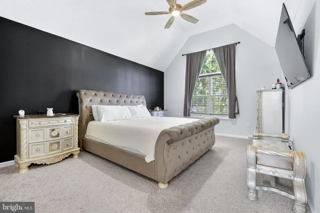 a bedroom with a bed and a couch