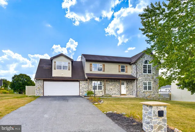 a front view of a house with swimming pool and outdoor seating