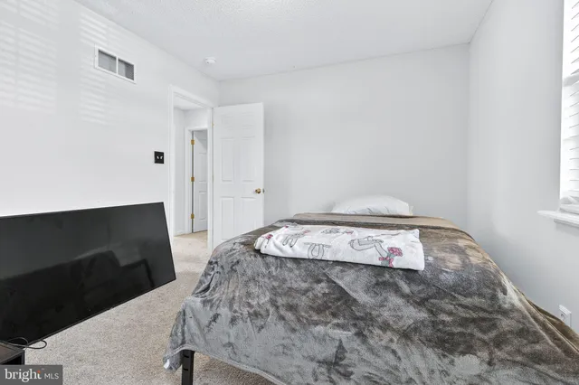 a bedroom with furniture and a window