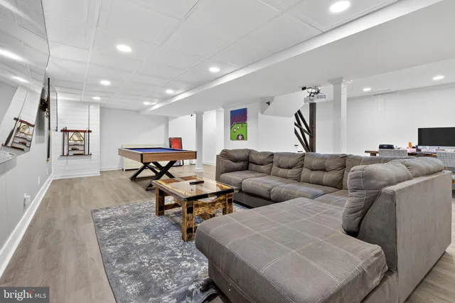 a living room with furniture pool table and a table