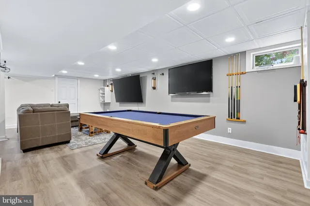 a kitchen with a table chairs refrigerator and microwave